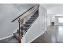 Modern staircase with dark metal balusters and gray carpeting at 116 Paulownia Cir, Mcdonough, GA 30253