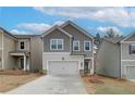 Two-story home with gray and beige siding, and attached garage at 4301 Portsbrook Ave, Snellville, GA 30039