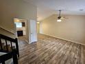 Open living room with vaulted ceiling, hardwood floors, and access to kitchen at 1378 Mill Lake Cir, Stone Mountain, GA 30088