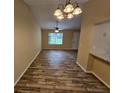 Bright dining area with hardwood floors and elegant light fixture at 1378 Mill Lake Cir, Stone Mountain, GA 30088