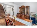 Formal dining room with a large wood table and hutch at 719 Sara Meadow Rd, Loganville, GA 30052