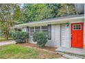 Brick home with red door and landscaping at 3189 Dogwood Dr, Atlanta, GA 30344