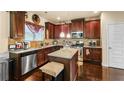 Spacious kitchen featuring granite countertops and dark wood cabinetry at 7619 Sugar Plum Ln, Lithonia, GA 30038