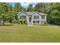 Two-story gray house with a spacious lawn and mature trees at 4050 Harvest Ridge Dr, Douglasville, GA 30135