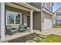 Inviting front porch with seating area, gray house exterior at 415 Splash Pointe, Temple, GA 30179