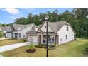 Two-story craftsman style home with front porch and landscaping at 67 Airmont Dr, Sharpsburg, GA 30277