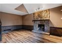 Living room with stone fireplace and hardwood floors at 6945 Butner Rd, Atlanta, GA 30349