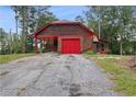 House exterior with a red door and attached garage at 6945 Butner Rd, Atlanta, GA 30349