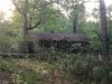 Small house with overgrown vegetation, needs landscaping at 2165 Old Salem Se Rd, Conyers, GA 30013