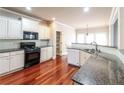 Spacious kitchen with granite countertops and hardwood floors at 1209 Richmond Rdg, Loganville, GA 30052