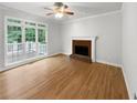 Gathering room with hardwood floors and brick fireplace at 9508 Greens Mill Ct, Loganville, GA 30052