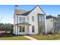 Two-story white farmhouse with gray accents and a metal roof at 6051 Stallion Rdg, Douglasville, GA 30135