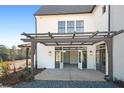 Covered patio with pergola and French doors leading inside at 6051 Stallion Rdg, Douglasville, GA 30135