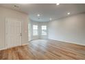 Spacious living room with hardwood floors and large windows offering natural light at 311 Tulip Dr, Covington, GA 30016