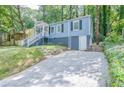 Charming blue house with a gravel driveway and a partially visible garage at 2836 Harlan Dr, Atlanta, GA 30344