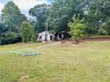 Small white cottage style home with green lawn at 35 Clayton Path, Douglasville, GA 30134
