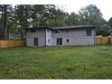 Back of house, showing a large yard and wooden fence at 3164 Columbia Woods Dr, Decatur, GA 30032