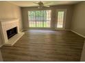 Living room with fireplace, vinyl flooring, and access to backyard at 435 Ridgedale Way, Lawrenceville, GA 30044