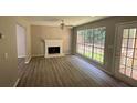 Living room with fireplace, vinyl flooring, and sliding glass doors at 435 Ridgedale Way, Lawrenceville, GA 30044