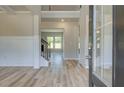 Bright and spacious entryway with wood-look flooring and views to the Gathering room at 201 Haverling Pass, Hampton, GA 30252