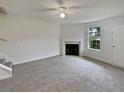 Bright living room with a fireplace and neutral carpeting at 9105 Sterling Lakes Cir, Covington, GA 30014