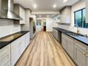 Modern kitchen with gray cabinets and a large island at 3624 Nessa Se Ct, Smyrna, GA 30082