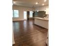 Open concept kitchen with island and dark hardwood floors at 7298 Rockhouse Rd # 5, Austell, GA 30168