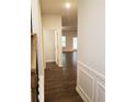 Bright hallway with dark hardwood floors and access to living areas at 7298 Rockhouse Rd # 5, Austell, GA 30168