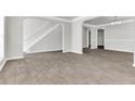 Open living room with grey wood-look floors at 2146 Silva Ct, Conley, GA 30288