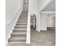Bright foyer with grey carpet staircase at 2146 Silva Ct, Conley, GA 30288