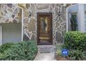 Inviting front entrance with stone facade and a charming glass door at 6280 Wiscasset Nw Pkwy, Dallas, GA 30157