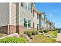 Townhouses with gray and blue siding, brick accents, and landscaping at 4433 Pinscher St, Union City, GA 30291