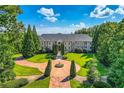 Grand estate home with circular driveway and fountain at 9620 Cedar Grove Rd, Chattahoochee Hills, GA 30213