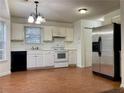 Kitchen with white cabinets, stainless steel fridge, and wood flooring at 1051 Foxchase Dr, Mcdonough, GA 30253