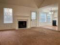 Bright living room features a fireplace and carpet at 1051 Foxchase Dr, Mcdonough, GA 30253