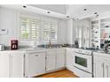 Bright eat-in kitchen, featuring white cabinetry, granite countertops, and stainless steel appliances at 1323 Briarcliff Ne Rd, Atlanta, GA 30306