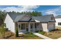 Two-story house with gray roof, brick, and light siding at 3749 Tielman St, Snellville, GA 30078