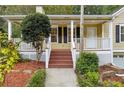 Inviting front porch with white columns and steps at 178 Seals Dr, Dallas, GA 30157