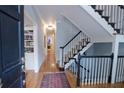 Bright entryway with hardwood floors, staircase, and built-in shelving at 3021 Margaret Mitchell Dr # 8, Atlanta, GA 30327