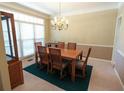 Formal dining room with hardwood floors, chandelier, and large windows at 4055 Vista Point Ln, Suwanee, GA 30024