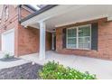 Front porch with brick columns and landscaping at 351 Chandler Bluff Ct, Grayson, GA 30017