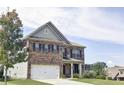 Two-story brick home with a three-car garage, front yard, and mature tree at 222 Gallant Fox Way, Acworth, GA 30102