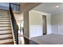 Elegant staircase with dark wood steps and a black metal railing at 222 Gallant Fox Way, Acworth, GA 30102