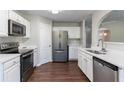 Modern kitchen features stainless steel appliances and white cabinetry at 7491 Garnet Dr, Jonesboro, GA 30236