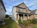 Two-story brick home with a front porch and landscaped yard at 925 Pegasus Way, Atlanta, GA 30349