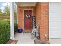 Inviting front door entrance with brick facade and welcome decor at 5989 Turfway Park Ct, Sugar Hill, GA 30518