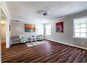 Spacious living room with hardwood floors, two accent chairs, and artwork at 3626 Buford Ne Hwy # C2, Brookhaven, GA 30329