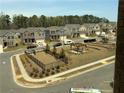 Aerial view of a new home community with playground and dog park at 3370 Reagan Way # 84, Lawrenceville, GA 30044