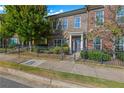 Front view of brick townhome with landscaping and black fence at 910 Westmoreland Nw Cir, Atlanta, GA 30318