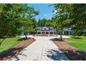 Long driveway leading to a luxurious farmhouse with a circular turnaround at 201 Edwards Brook Ct, Canton, GA 30115